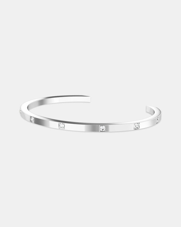 A plated stainless steel bangle in silver from Waldor & Co. One size. The model is Brilliant Bangle Polished