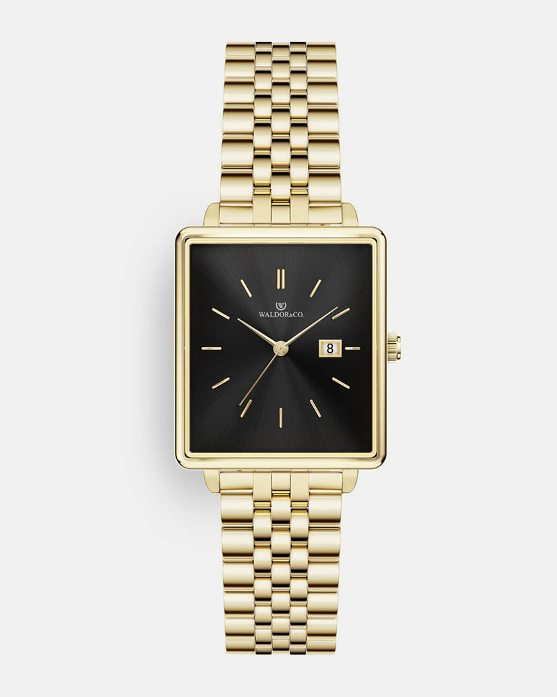 A square womens watch in 14k gold from Waldor & Co. with black sunray dial and a second hand. Seiko movement. The model is Delight 32 Chelsea 28x32mm. 