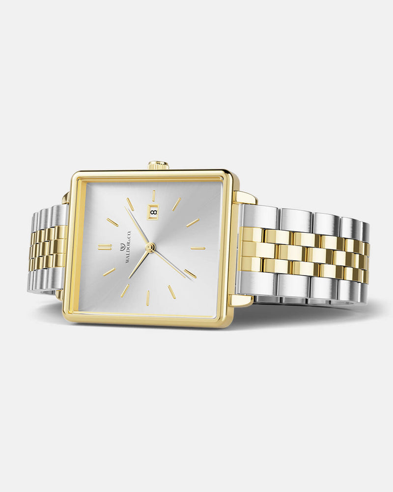A square womens watch in silver and 14k gold from Waldor & Co. with silver sunray dial and a second hand. Seiko movement. The model is Delight 32 Chelsea 28x32mm. 