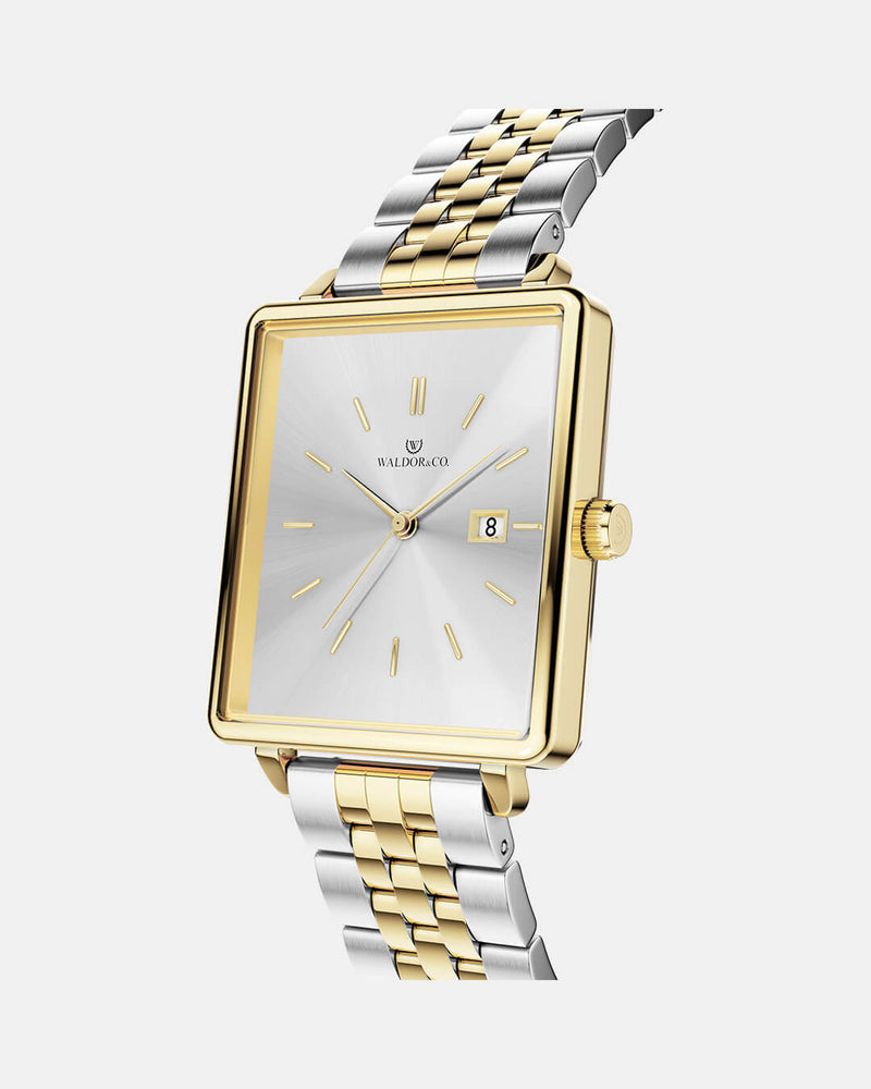 A square womens watch in silver and 14k gold from Waldor & Co. with silver sunray dial and a second hand. Seiko movement. The model is Delight 32 Chelsea 28x32mm. 