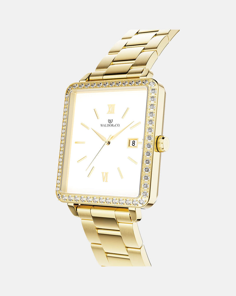 A square womens watch in 22k gold-plated 316L stainless steel with stones from WALDOR & CO. with black sunray dial and a second hand. Seiko VJ22 movement. The model is Delight 32 Mayfair 28x32mm. 