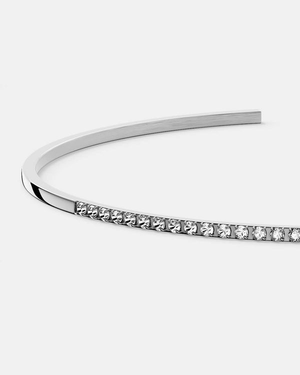 A Bangle in Rhodium-plated 316L stainless steel from Waldor & Co. One size. The model is Bliss Bangle Polished.