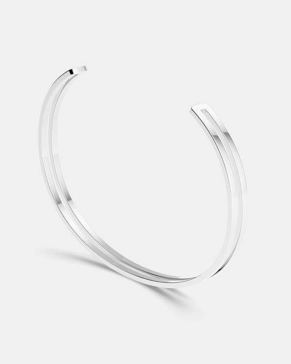  A polished stainless steel bangle in silver from Waldor & Co. One size. The model is Dual Bangle Polished. 