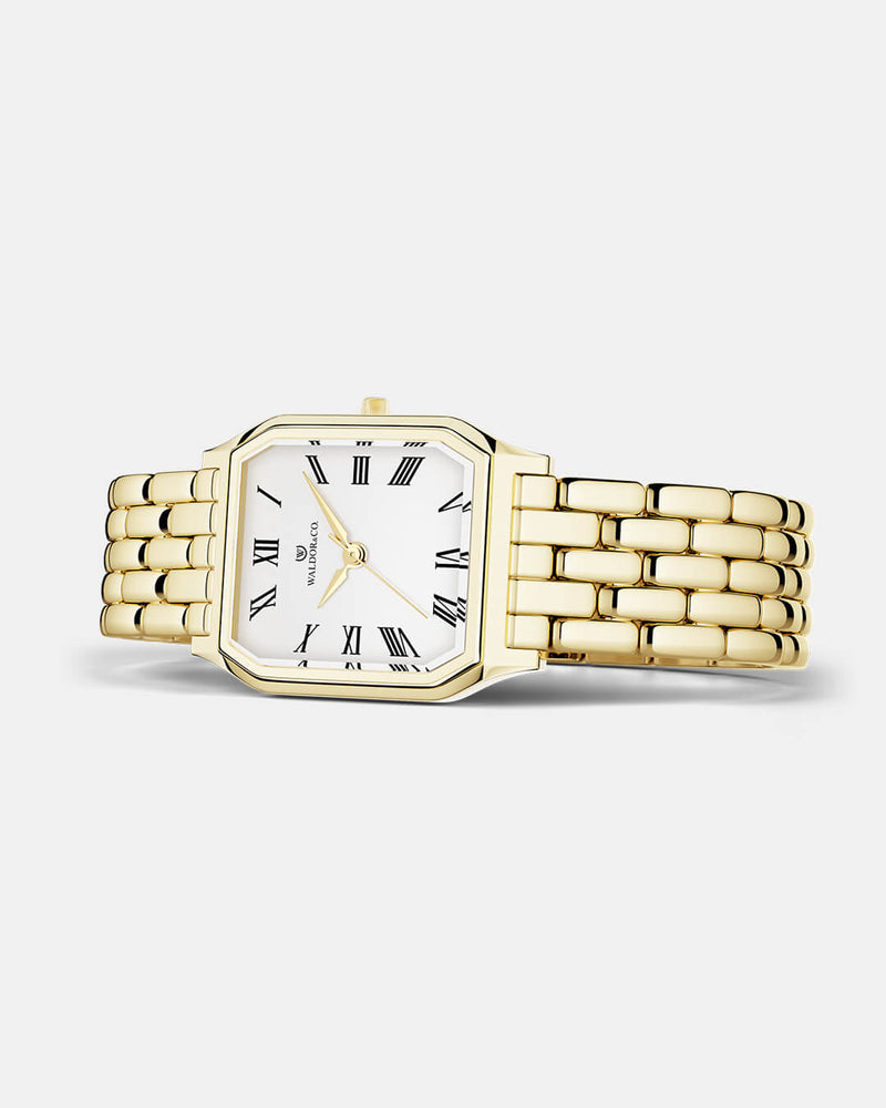 A square womens watch in 22k gold from Waldor & Co. with white Diamond Cut Sapphire Crystal glass dial. Seiko movement. The model is Eternal 22 Bellagio.